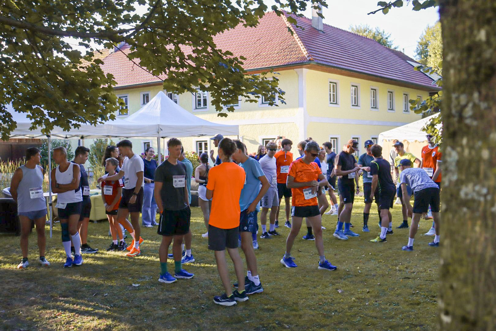 Läufer:innen versammeln sich vor dem Start am Hof, 2025
